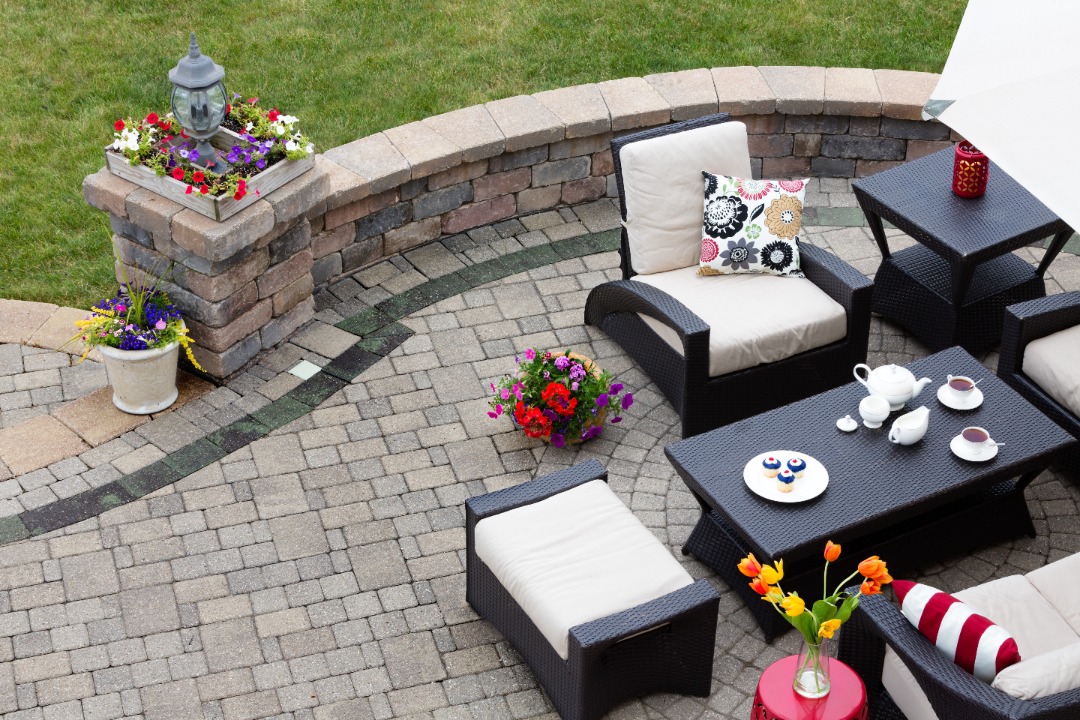 A patio transformed with fresh new plants and furniture.