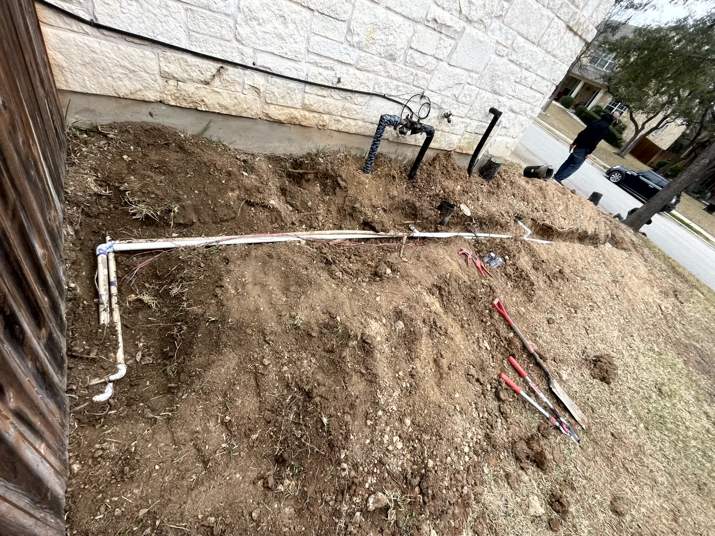 Our professional crew is fixing a leaking irrigation pipe.