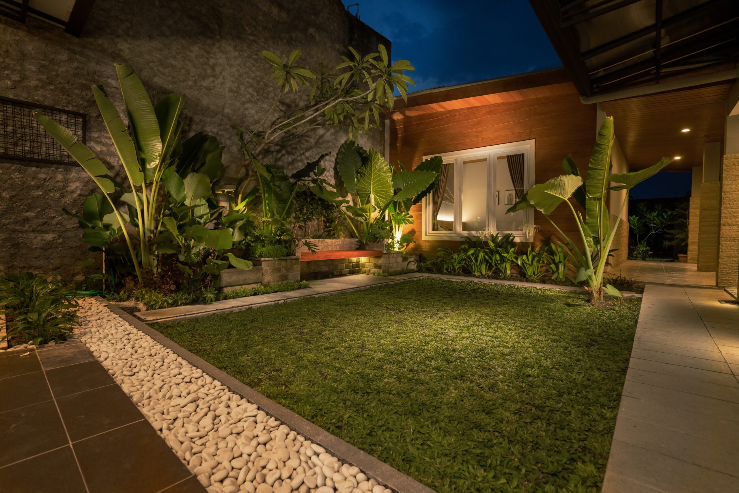 A nice courtyard area with lighting seamlessly put around the plants.