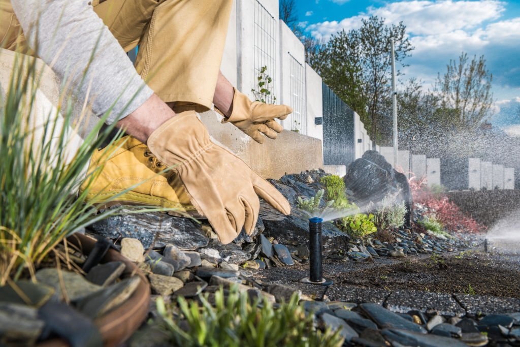 A professional handling an irrigation system.