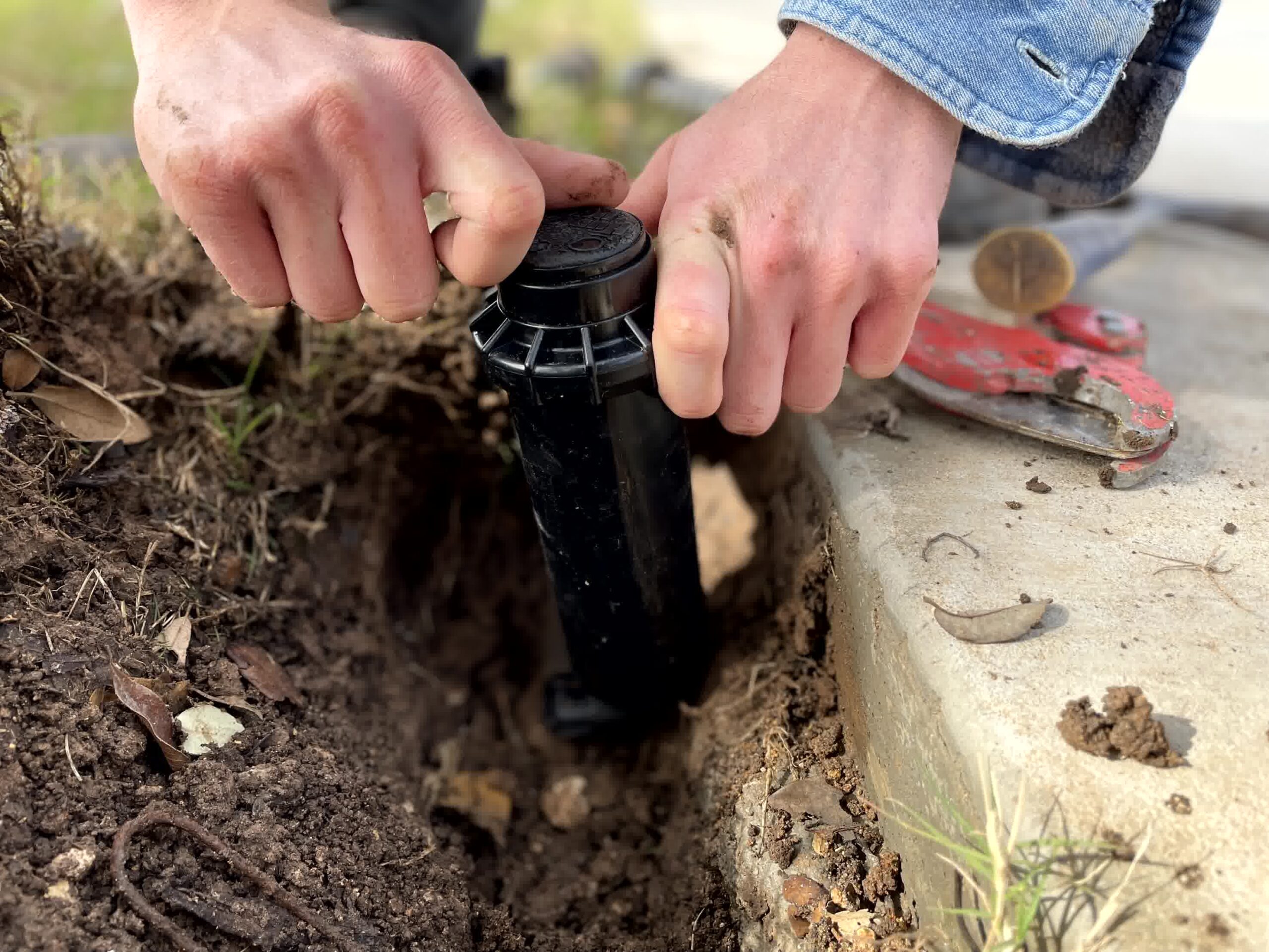 A professional taking care of a quick irrigation repair.