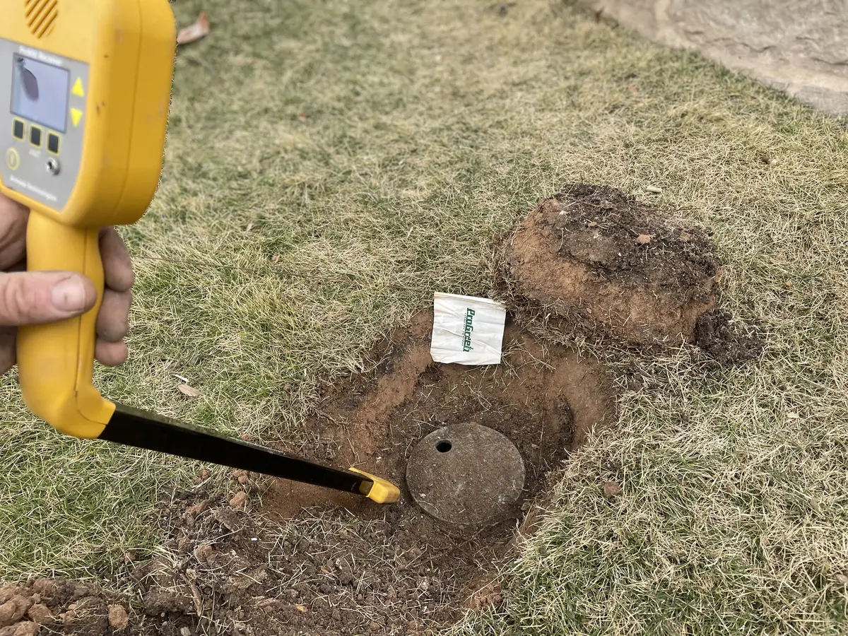 Broken irrigation lines and exposed wires revealed during inspection and troubleshooting of underground sprinkler system.